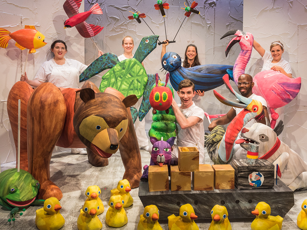 Photo of the full cast of The Very Hungry Caterpillar holding a variety of puppets from the show.