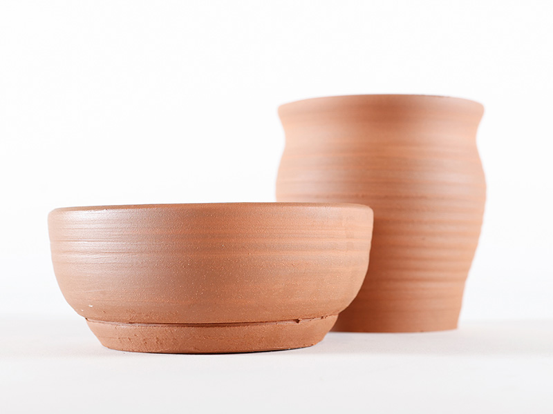 Photo of two unpainted clay pots.