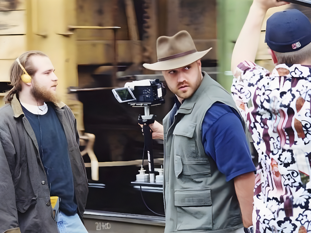 Photo of Craig Brewer holding a camera on the set of 'The Poor and Hungry.'