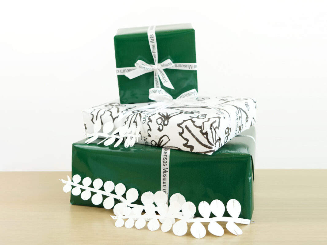 Photo of green and white gift-wrapped presents with AMFA ribbons.
