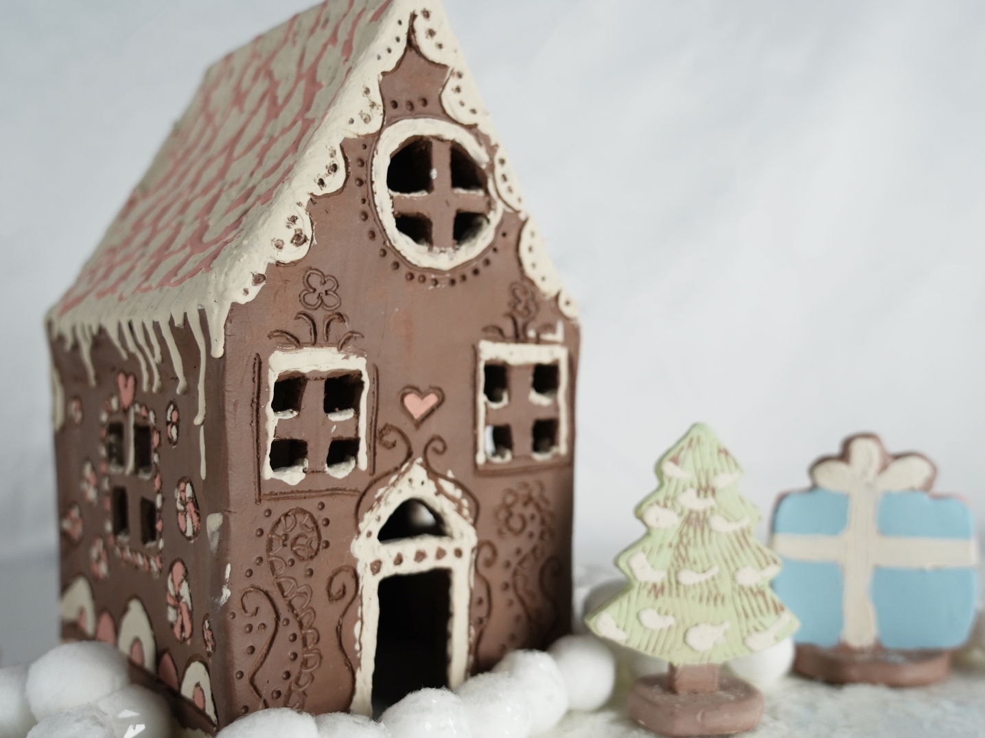 Photo of a handmade clay gingerbread house.