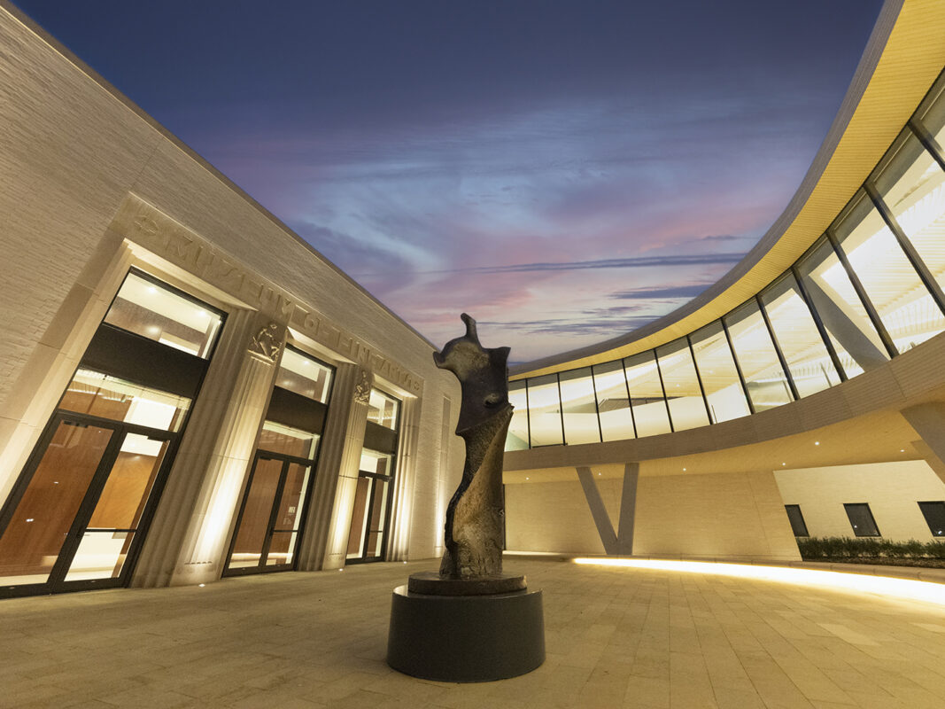 Nighttime photo of a bronze sculpture by Henry Moore at the Courtyard Entrance to AMFA.