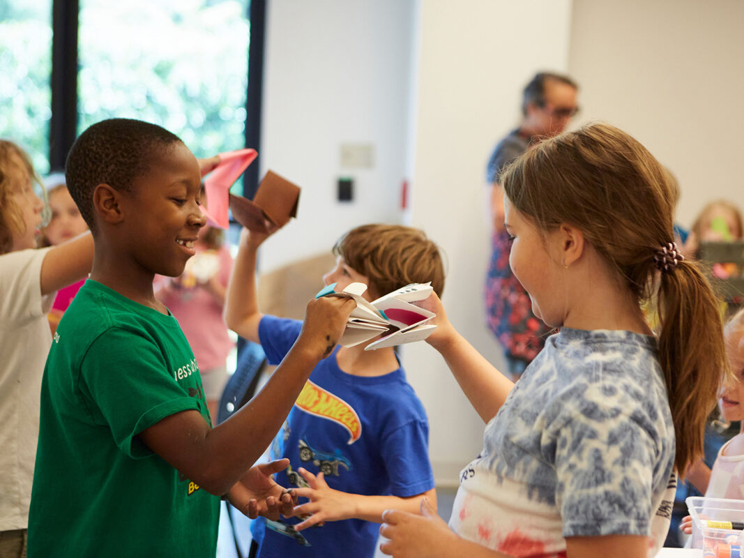 Photo of two children playing with hand puppets.