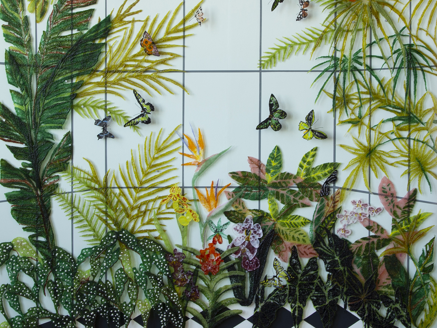 Detail photo of a glass artwork by Kate Clements depicting plants, flowers, and butterflies in a greenhouse.