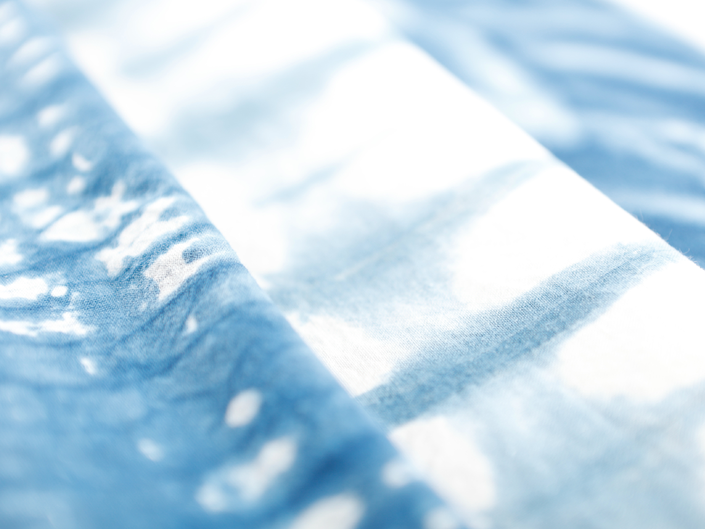Close-up photo of a blue tie-dyed scarf.