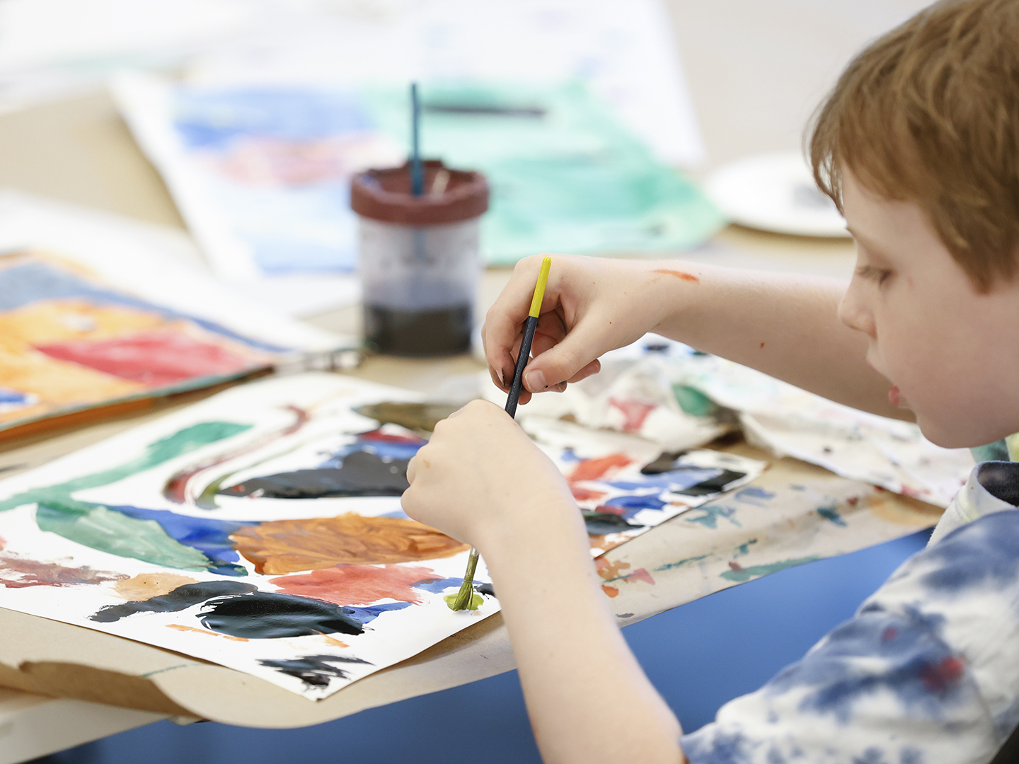 Photo of a young boy painting.