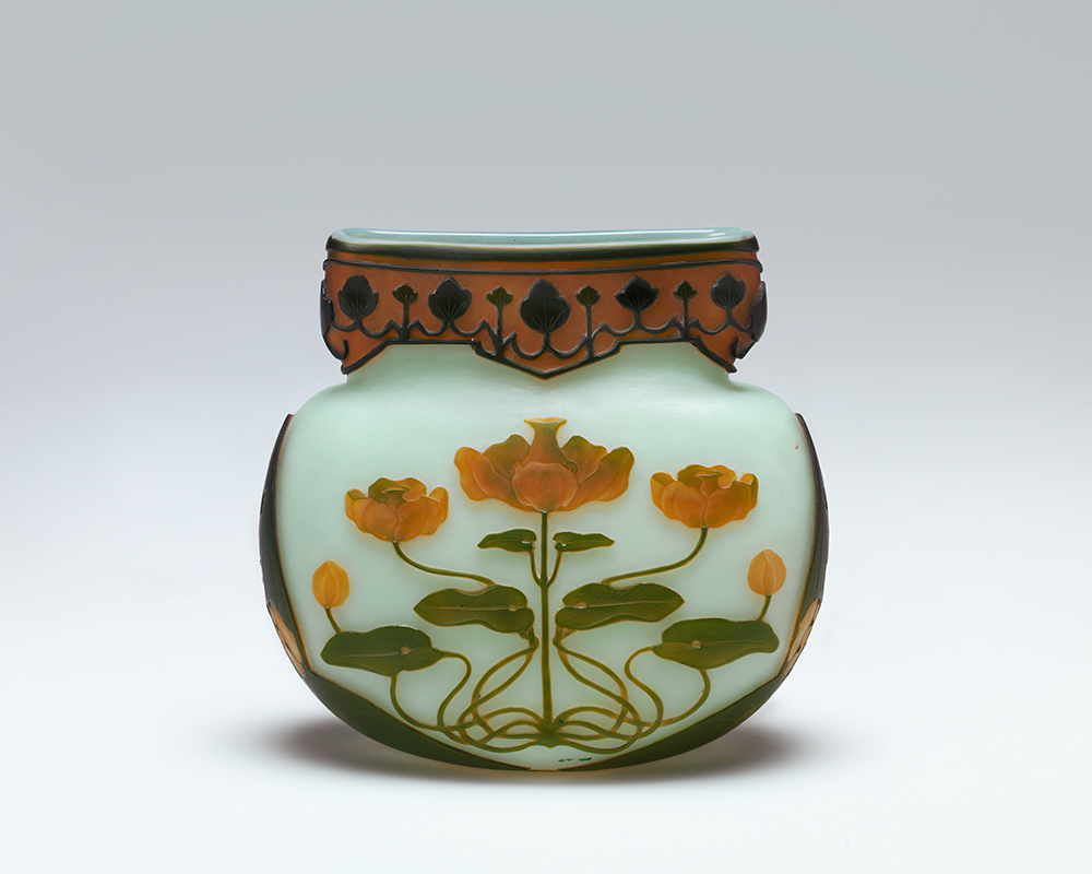 Photo of a small porcelain vase painted with a waterlily flower design.