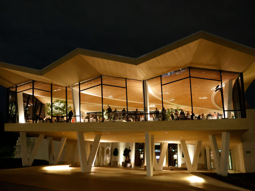 Photo of the Cultural Living Room at AMFA viewed at night from the outside.