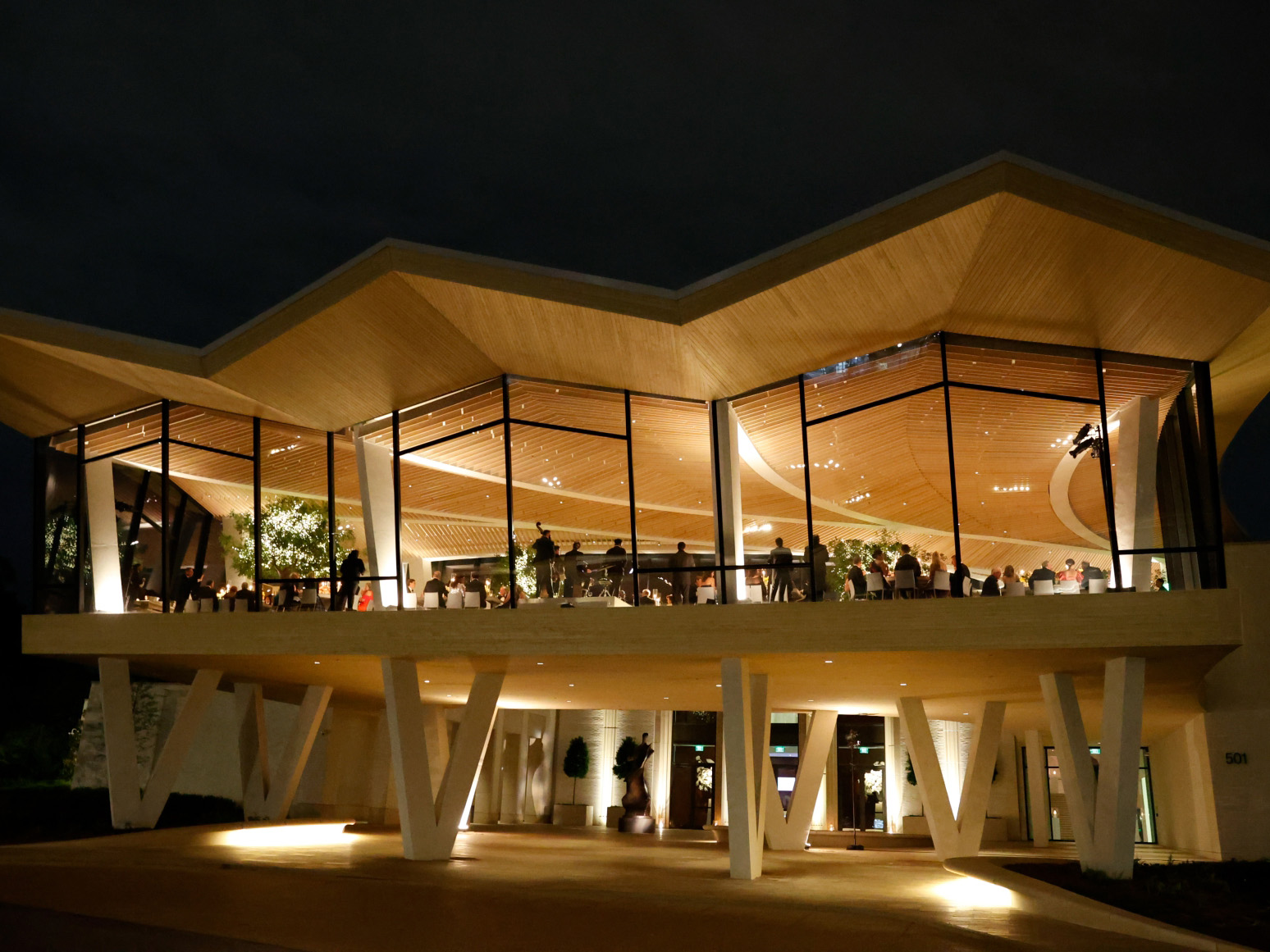 Photo of the Cultural Living Room at AMFA viewed at night from the outside.