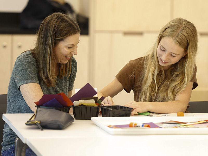 Photo of a mother and daughter doing an art activity in an art studio.