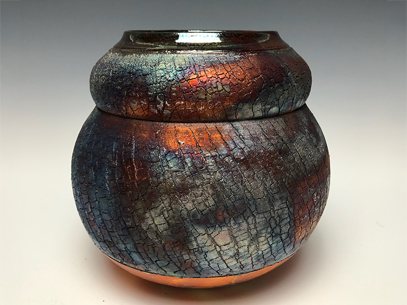 Photo of a handmade, Raku-fired ceramic vase.