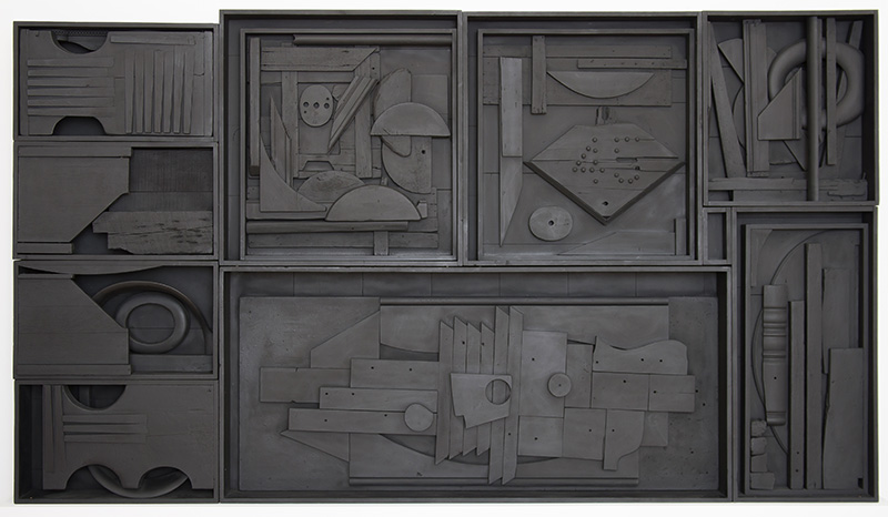 Photo of a sculpture by Louise Nevelson comprised of several wooden boxes filled with wooden objects configured together and painted black.