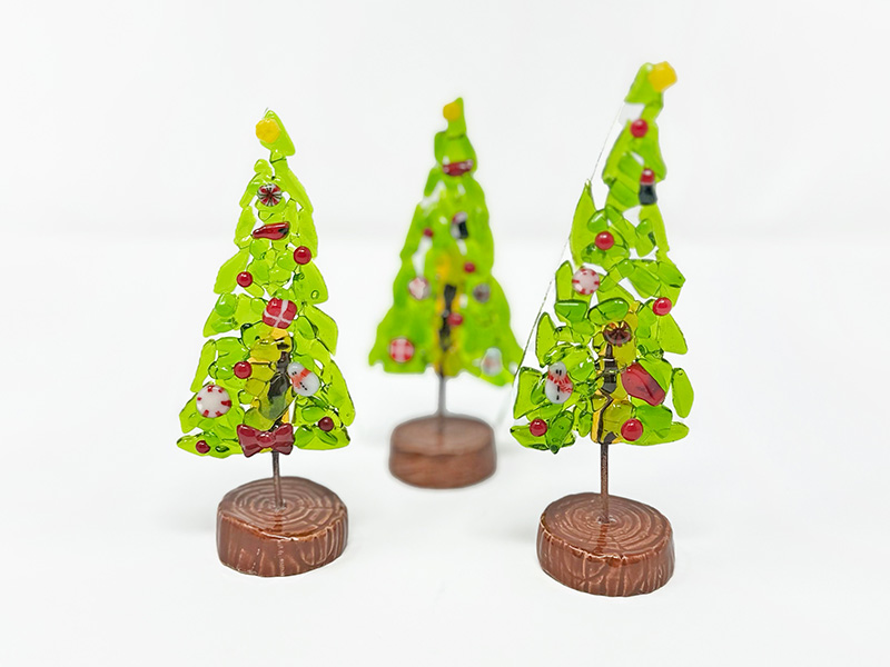Photo of three small handmade glass holiday trees.