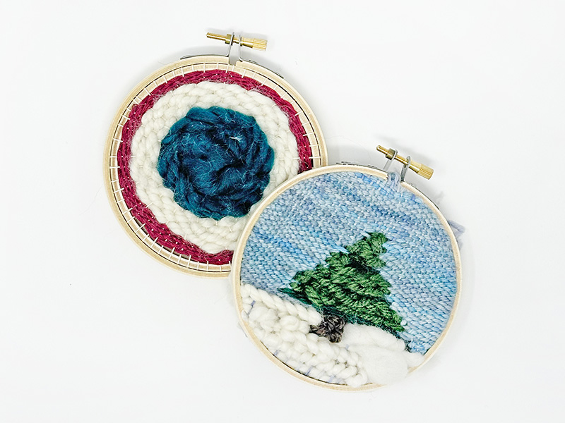 Photo of two small circle looms. The loom on the left has a multicolored concentric circle pattern. The loom on the right depicts a pine tree on a snowy background.
