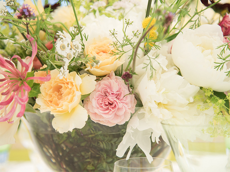 Close-up photo of a floral arrangement of white, yellow, and pink flowers.